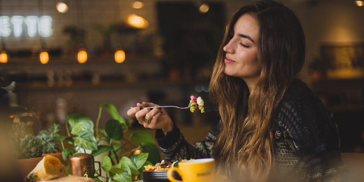 Woman Eating Healthy Food at Restaurant